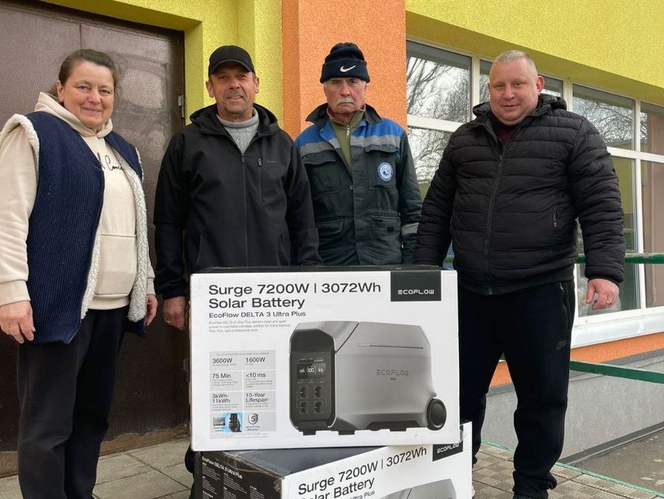 Чотири людини стоять біля коробки із сонячною батареєю EcoFlow DELTA 3 Ultra Plus із зазначенням потужності 7200Вт та ємності 3072 Вт/год.